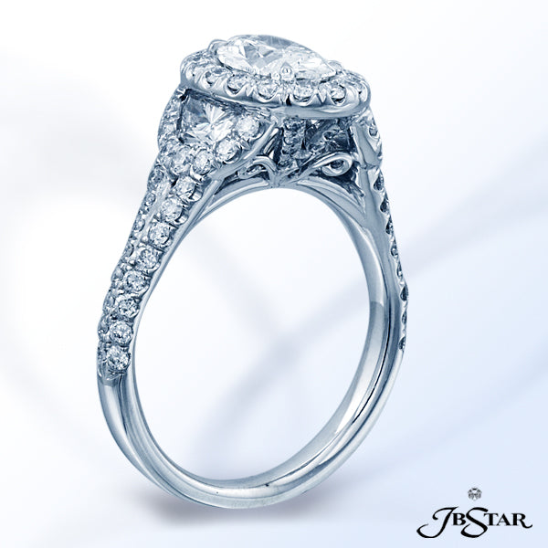JB STAR PLATINUM DIAMOND RING FEATURING A 1.0 CT OVAL DIAMOND ENCIRCLED BY ROUND DIAMONDS AND EMBRAC