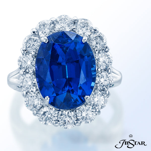 JB STAR FEATURED IN THIS EXQUISITE PLATINUM RING IS A 8.26CT OVAL TANZANITE CENTER ENCIRCLED WITH 14