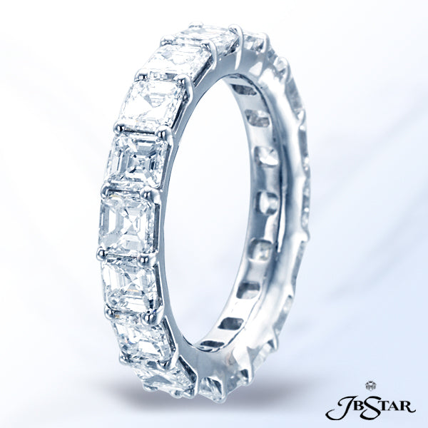 JB STAR THIS EXQUISITELY HANDCRAFTED, PLATINUM, ETERNITY BAND FEATURES 18 SQUARE EMERALD-CUT DIAMOND