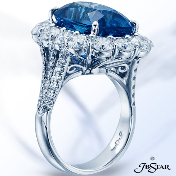 JB STAR HANDCRAFTED, THIS STUNNING RING FEATURES A 16.69CT NO HEAT SAPPHIRE CUSHION CENTER ENCIRCLED