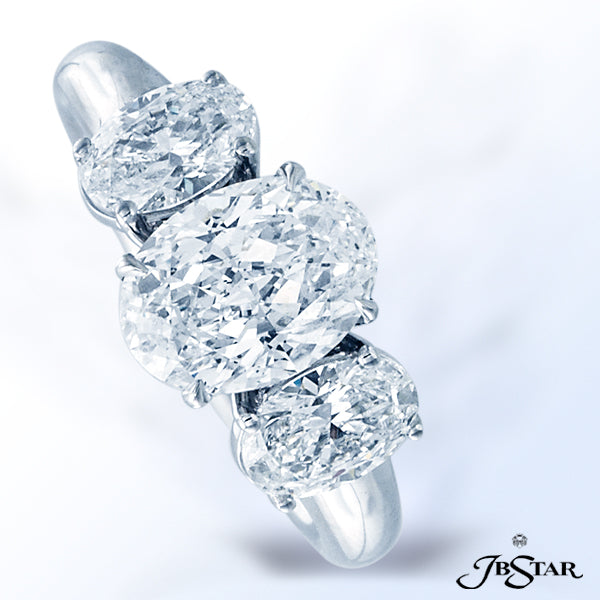 JB STAR DIAMOND RING FEATURING A LOVELY 2.03 CT OVAL DIAMOND EMBRACED BY TWO ADDITIONAL PERFECTLY MA